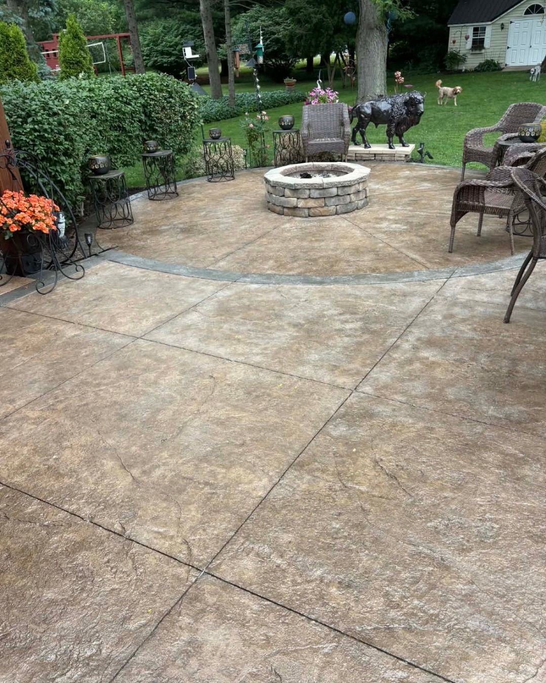 Stamped concrete patio with a stone fire pit installed in Buffalo NY